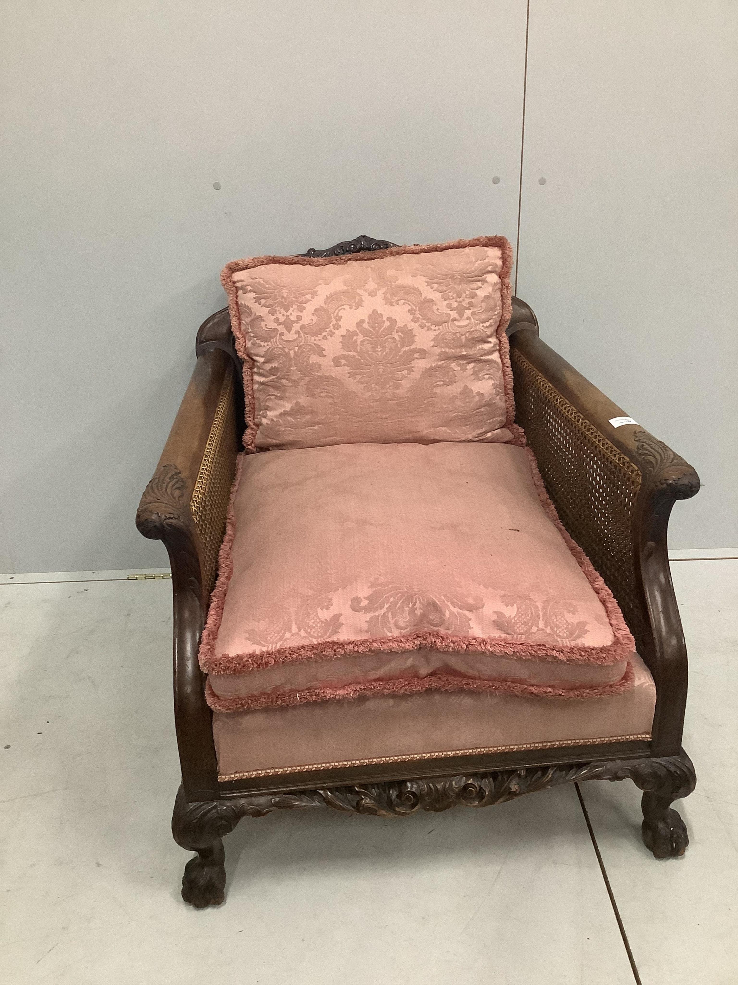 A 1930's mahogany three piece Bergere suite, with double caned arms and single caned backs. Condition - some fading with small damages to the caning